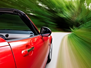 red car driving fast